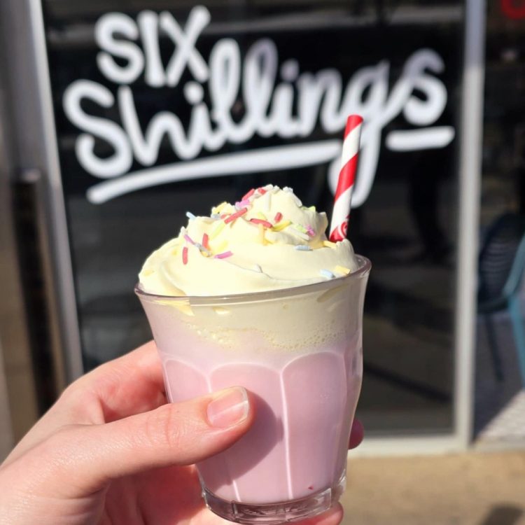 Blended strawberry shake topped with cream and sprinkles